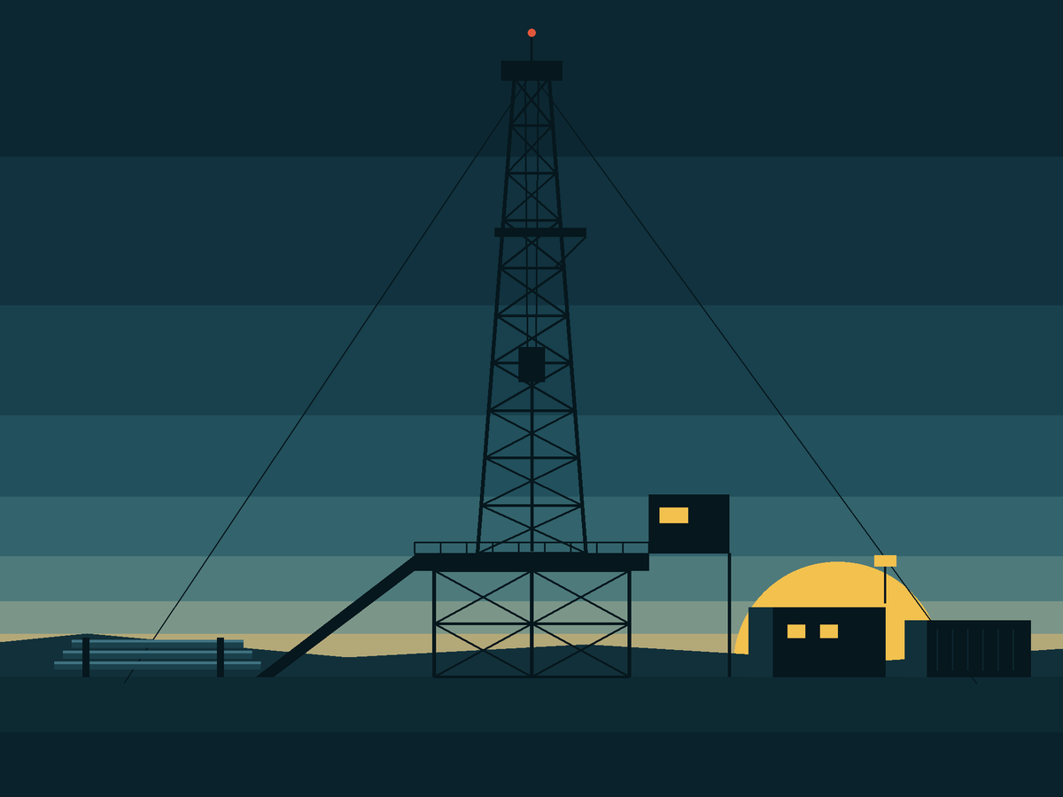 A land drilling rig and site cabins at sunset